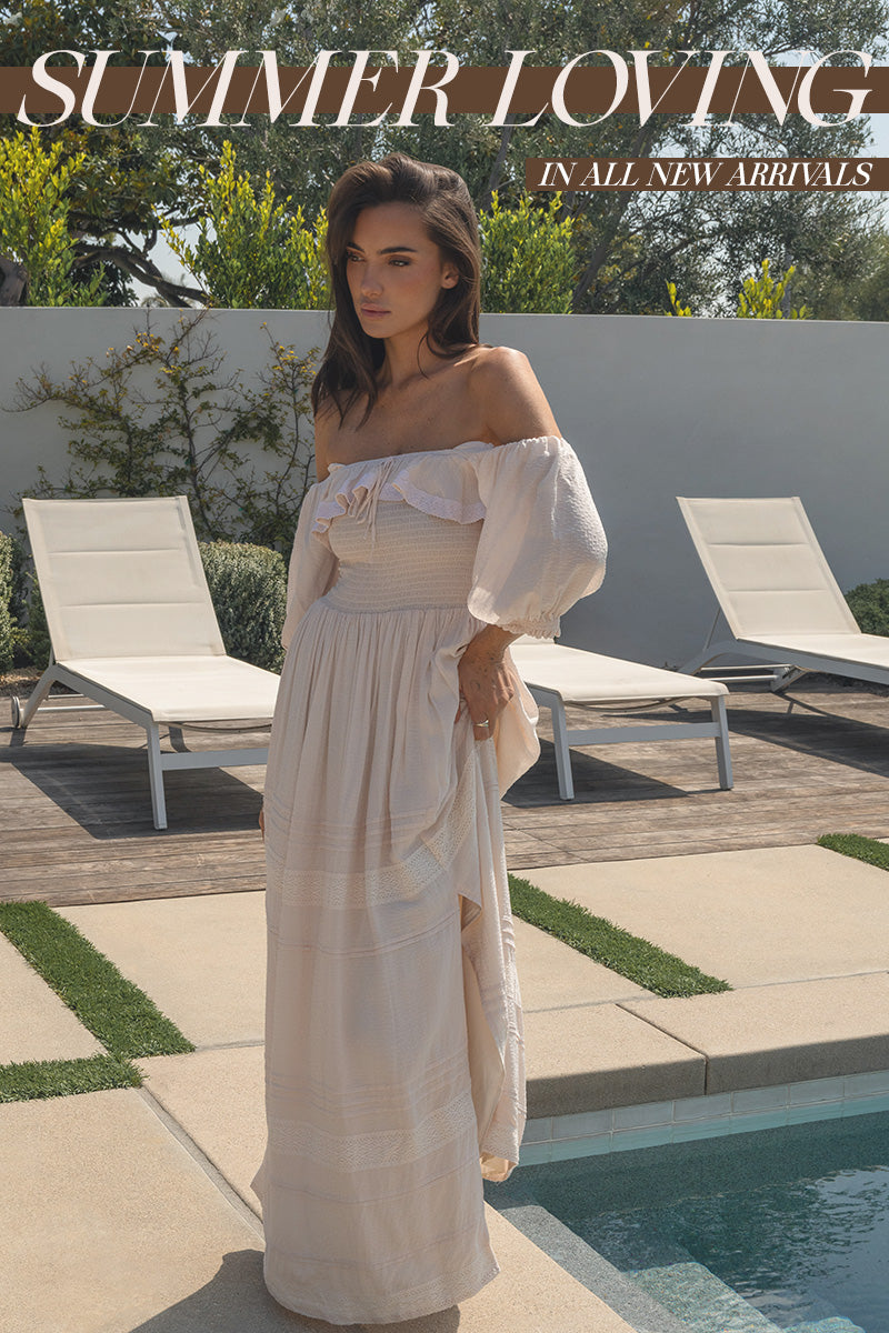 Woman in a white dress standing by a pool with 'Summer Loving' text overlay.