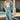 A full body front view of a woman wearing the Saltwater Luxe in front of a pool