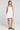 Front view of a woman wearing the Saltwater Luxe Adelina Mini Dress in White on a neutral background