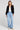 A full body front view of a woman wearing the Saltwater Luxe Aden Black Sweater on a neutral background
