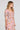 Side angle view of a woman wearing the Saltwater Luxe Amarra Multicolored Top on a neutral background
