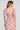 Back view of a woman wearing the Saltwater Luxe Amarra Multicolored Top on a neutral background