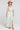 A full body front view of a woman wearing the Saltwater Luxe Amarra Pearl Top  on a neutral background