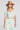 Front view of a woman wearing the Saltwater Luxe Amarra Pearl Top  on a neutral background