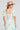 Back view of a woman wearing the Saltwater Luxe Amarra Pearl Top  on a neutral background