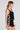 Side angle view of a woman wearing the Saltwater Luxe Ardenn Black Tank on a neutral background
