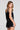 Back view of a woman wearing the Saltwater Luxe Ardenn Black Tank on a neutral background