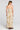 Back view of a woman wearing the Saltwater Luxe  Arosa Midi Dress in Fawn on a neutral background