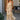 Back view of a woman wearing the Saltwater Luxe  Arosa Midi Dress in Fawn in front of a house
