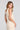 Back view of a woman wearing the Saltwater Luxe Ashbee Tank in Natural on a neutral background
