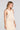 Side angle view of a woman wearing the Saltwater Luxe Ashbee Tank in Natural on a neutral background