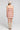 Back view of a woman wearing the Saltwater Luxe Bette Mini Dress in Natural on a neutral background