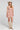 Front view of a woman wearing the Saltwater Luxe Bette Mini Dress in Natural on a neutral background