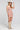 Side angle view of a woman wearing the Saltwater Luxe Bette Mini Dress in Natural on a neutral background
