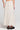 Back view of a woman wearing the Saltwater Luxe  Beverley Midi Skirt on a neutral background