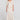 Full body front view of a woman wearing the Saltwater Luxe  Beverley Midi Skirt on a neutral background