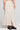 Side angle view of a woman wearing the Saltwater Luxe  Beverley Midi Skirt on a neutral background