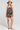 Full body front view of a woman wearing the Saltwater Luxe Bristal Romper in Black on a neutral background