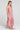 Side angle view of a woman wearing the Saltwater Luxe Bryent Midi Dress in Coffee on a neutral background