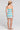 Back view of a woman wearing the Saltwater Luxe Camdyn Mini Dress on a neutral background