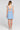Back view of a woman wearing the Saltwater Luxe Carson Mini Dress in Dusty Blue on a neutral background
