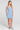 Front view of a woman wearing the Saltwater Luxe Carson Mini Dress in Dusty Blue on a neutral background