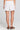 Back view of a woman wearing the Saltwater Luxe Celestia Short on a neutral background