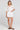 Full body front view of a woman wearing the Saltwater Luxe Celestia Short on a neutral background