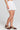 Side angle view of a woman wearing the Saltwater Luxe Celestia Short on a neutral background