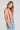 Side angle view of a woman wearing the Saltwater Luxe Chelsee Natural Top on a neutral background