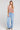A full body front view of a woman wearing the Saltwater Luxe Chelsee Natural Top on a neutral background