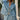 Front view of a woman wearing the Saltwater Luxe Delmar Jacket in Dusty Blue in a garden