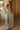 front view of a woman wearing the Saltwater Luxe Dorit Jumper in a kitchen
