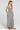 Side angle view of a woman wearing the Saltwater Luxe Dorit Jumper on a neutral background