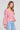 Side angle view of a woman wearing the Saltwater Luxe Ellyn Sweater in Mulberry on a neutral background