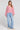 A full body front view of a woman wearing the Saltwater Luxe Ellyn Sweater in Mulberry on a neutral background