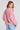 Back view of a woman wearing the Saltwater Luxe Ellyn Sweater in Mulberry on a neutral background