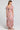 Back view of a woman wearing the Saltwater Luxe Evra Maxi Dress on a neutral background