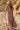 Front view of a woman wearing the Saltwater Luxe Evra Maxi Dress on a sandy beach