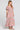 Side angle view of a woman wearing the Saltwater Luxe Evra Maxi Dress on a neutral background