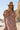 Front view of a woman wearing the Saltwater Luxe Evra Maxi Dress on a beach