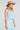 Side angle view of a woman wearing the Saltwater Luxe aelle Tank in Azure Blue on a neutral background