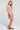 Side angle view of a woman wearing the Saltwater Luxe Genneva Mini Dress in Coffee on a neutral background