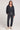 A full body front view of a woman wearing the Saltwater Luxe Half Zip Black Seam Pullover on a neutral background