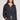 Front view of a woman wearing the Saltwater Luxe Half Zip Black Seam Pullover on a neutral background