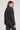 Back view of a woman wearing the Saltwater Luxe Half Zip Black Seam Pullover on a neutral background