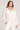 Front view of a woman wearing the Saltwater Luxe  Half Zip Ecru Seam Pullover on a neutral background