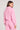 Back view of a woman wearing the Saltwater Luxe Half Zip Petunia Seam Pullover on a neutral background