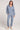 A full body front view of a woman wearing the Saltwater Luxe Half Zip Worn Blue Seam Pullover on a neutral background