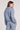 Back view of a woman wearing the Saltwater Luxe Half Zip Worn Blue Seam Pullover on a neutral background